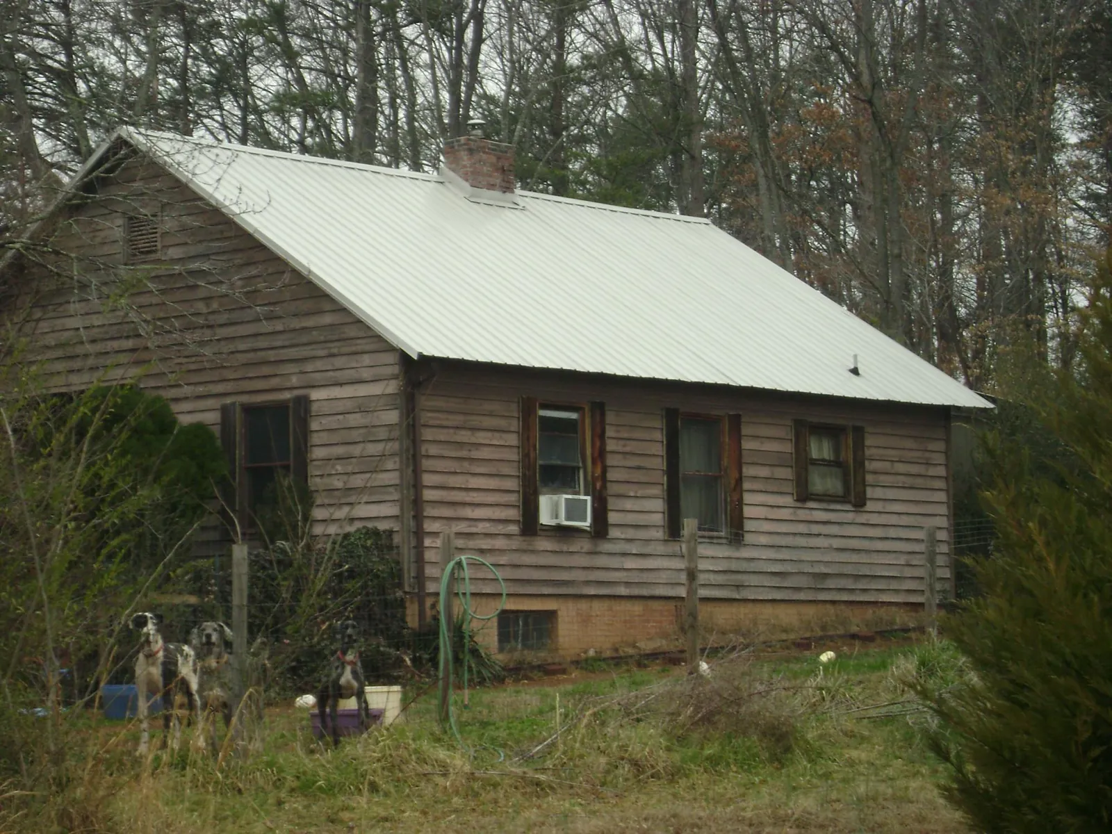 White metal roof on an old wood sided farmhouse, from a Metal Roof Installation job in Abington